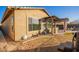 Exterior view showcasing the home's stucco, stone accents, covered patio, outdoor kitchen and manicured landscaping at 29794 N Little Leaf Dr, San Tan Valley, AZ 85143