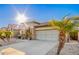 A well-maintained home exterior featuring desert landscaping and an attached garage at 29794 N Little Leaf Dr, San Tan Valley, AZ 85143