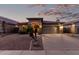 Charming one-story home featuring a stone facade, desert landscaping, and a two-car garage at dusk at 29794 N Little Leaf Dr, San Tan Valley, AZ 85143