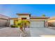 Attractive single-story home boasts desert landscaping, stone accents and a convenient two-car garage at 29794 N Little Leaf Dr, San Tan Valley, AZ 85143