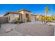 Charming single-story home features a well-maintained desert landscape, stone accents and a two car garage at 29794 N Little Leaf Dr, San Tan Valley, AZ 85143
