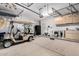 Well-organized garage with golf cart, overhead storage racks, utility sink, and ample space at 29794 N Little Leaf Dr, San Tan Valley, AZ 85143