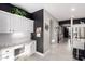 Hallway with a desk, white cabinets, granite counters, and access to other rooms at 29794 N Little Leaf Dr, San Tan Valley, AZ 85143
