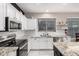 Bright kitchen with white cabinets, granite countertops, stainless steel appliances, and modern finishes at 29794 N Little Leaf Dr, San Tan Valley, AZ 85143