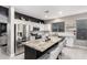 Bright kitchen featuring a large island with bar seating, stainless steel appliances, and stylish decor at 29794 N Little Leaf Dr, San Tan Valley, AZ 85143