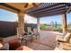 Covered patio features a ceiling fan and an outdoor dining area perfect for entertaining guests at 29794 N Little Leaf Dr, San Tan Valley, AZ 85143