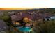 Aerial view of an estate featuring a swimming pool and desert landscaping at dusk at 30311 N 52Nd Pl, Cave Creek, AZ 85331
