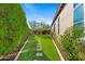Beautifully landscaped backyard with lush lawn, stone pathway, and mature trees at 30311 N 52Nd Pl, Cave Creek, AZ 85331