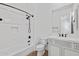 White bathroom with tiled walls, shower-tub combo and vanity with storage at 30311 N 52Nd Pl, Cave Creek, AZ 85331