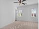 Bright bedroom with ceiling fan, neutral carpet, and plantation shutters at 30311 N 52Nd Pl, Cave Creek, AZ 85331