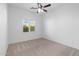 Bright bedroom with ceiling fan, neutral carpet, and plantation shutters at 30311 N 52Nd Pl, Cave Creek, AZ 85331