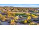 Aerial view of neighborhood park with a green space, playground, and desert landscape at 30311 N 52Nd Pl, Cave Creek, AZ 85331