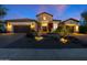 Charming exterior of a home with a desert landscape, a stone facade, and a two-car garage at 30311 N 52Nd Pl, Cave Creek, AZ 85331