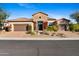 Exterior shot of a home with three car garage and stone front entrance with beautiful desert landscaping at 30311 N 52Nd Pl, Cave Creek, AZ 85331