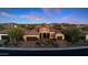 Stunning desert home featuring lush landscaping, a stone facade, and a tile roof, set against a mountain backdrop at 30311 N 52Nd Pl, Cave Creek, AZ 85331