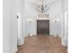 Grand foyer featuring high ceilings, a wrought iron chandelier, stone floors, and a beautiful arched entryway at 30311 N 52Nd Pl, Cave Creek, AZ 85331