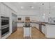 Bright kitchen features white cabinetry, stainless steel appliances, a kitchen island and stylish pendant lighting at 30311 N 52Nd Pl, Cave Creek, AZ 85331