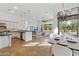 Modern kitchen flows to living area, featuring granite countertops, an island, and abundant natural light at 30311 N 52Nd Pl, Cave Creek, AZ 85331