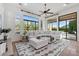 Bright living room featuring a sectional sofa, large windows, and stylish decor creating an inviting space at 30311 N 52Nd Pl, Cave Creek, AZ 85331