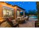 Backyard with a stone fire pit, outdoor seating, and swimming pool under the covered patio at 30311 N 52Nd Pl, Cave Creek, AZ 85331