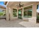 Spacious covered patio with ceiling fan, stone flooring, and large windows for seamless indoor-outdoor living at 30311 N 52Nd Pl, Cave Creek, AZ 85331