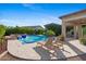 Inviting pool area featuring a waterfall spa, lounge chairs, and professionally designed landscaping at 30311 N 52Nd Pl, Cave Creek, AZ 85331