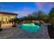 Backyard swimming pool with spa, lush desert landscaping, and tiled patio under the dawn sky at 30311 N 52Nd Pl, Cave Creek, AZ 85331