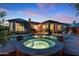 Stunning backyard featuring a pool, spa, lush landscaping, and outdoor lounge area at 30311 N 52Nd Pl, Cave Creek, AZ 85331