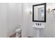 Stylish powder room with pedestal sink, decorative sconces, and framed mirror at 30311 N 52Nd Pl, Cave Creek, AZ 85331