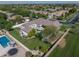 An aerial view highlighting the home's backyard oasis with pool, landscaping, and surrounding neighborhood at 3173 E Page Ave, Gilbert, AZ 85234