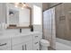 Well-lit bathroom featuring a large mirror, white vanity, and a shower-tub combination at 3173 E Page Ave, Gilbert, AZ 85234