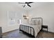 Cozy bedroom with a black metal bed frame, neutral bedding, and a patterned rug at 3173 E Page Ave, Gilbert, AZ 85234