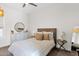 Bright bedroom with a wooden headboard, neutral bedding, and decorative accents at 3173 E Page Ave, Gilbert, AZ 85234