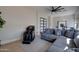 Comfortable bonus room with a sectional sofa, workout equipment, and a stylish ceiling fan at 3173 E Page Ave, Gilbert, AZ 85234