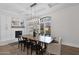 Elegant dining room with a modern chandelier, a large window, and a fireplace with brickwork design at 3173 E Page Ave, Gilbert, AZ 85234