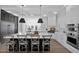 Modern kitchen with a large island, white cabinets, and stainless steel appliances at 3173 E Page Ave, Gilbert, AZ 85234