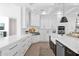 Stylish white kitchen with an island, modern appliances, bright lighting and a beautiful backsplash design at 3173 E Page Ave, Gilbert, AZ 85234