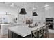 Bright kitchen features a large island with white countertop, modern appliances, and stylish pendant lighting at 3173 E Page Ave, Gilbert, AZ 85234