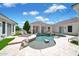 Backyard pool area complete with a rock waterfall feature and travertine tile decking at 3173 E Page Ave, Gilbert, AZ 85234