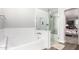 Bright bathroom featuring a separate tub and a glass block shower at 333 N Pennington Dr # 15, Chandler, AZ 85224