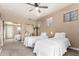 Bright bedroom featuring two twin beds, ceiling fan, and mirrored closet at 333 N Pennington Dr # 15, Chandler, AZ 85224