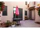 Enclosed patio features cozy seating, lush flowering plants, and a peaceful ambiance, perfect for outdoor relaxation and entertainment at 333 N Pennington Dr # 15, Chandler, AZ 85224