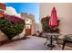 Private courtyard with an umbrella table set next to colorful bougainvillea and a gated entryway, a perfect outdoor retreat at 333 N Pennington Dr # 15, Chandler, AZ 85224