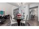 Modern dining area with stylish light fixture, sleek furniture, and neutral tones perfect for intimate gatherings and entertaining at 333 N Pennington Dr # 15, Chandler, AZ 85224