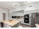 Large kitchen with stainless steel appliances, gray cabinets, island, and granite countertops at 333 N Pennington Dr # 15, Chandler, AZ 85224