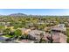 Breathtaking aerial view of the neighborhood and a home with mountain views beyond the tree-lined community at 3353 E Nolan Dr, Chandler, AZ 85249