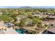Expansive aerial view showcasing the lush neighborhood, scenic mountain backdrop, and sparkling private pool at 3353 E Nolan Dr, Chandler, AZ 85249