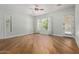 Bright bedroom with wood floors, a ceiling fan, and access to the backyard at 3353 E Nolan Dr, Chandler, AZ 85249