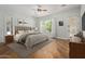 Calming bedroom with hardwood floors, a neutral color scheme, and a view of the backyard at 3353 E Nolan Dr, Chandler, AZ 85249