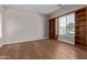 Bedroom featuring hardwood floors, a window, and built-in bookshelves at 3353 E Nolan Dr, Chandler, AZ 85249
